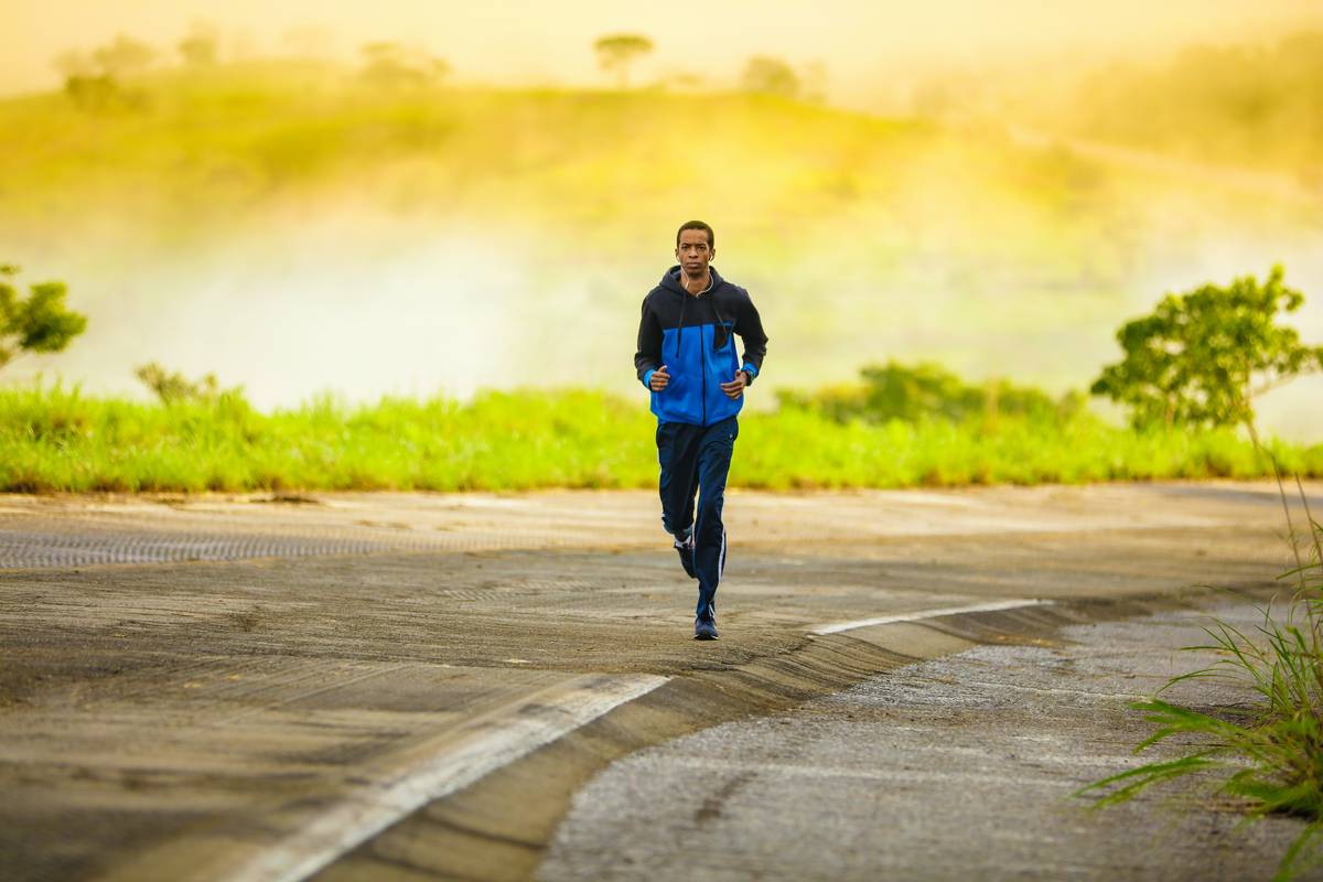 training for runners beginners showing a new runner stretching near a park path