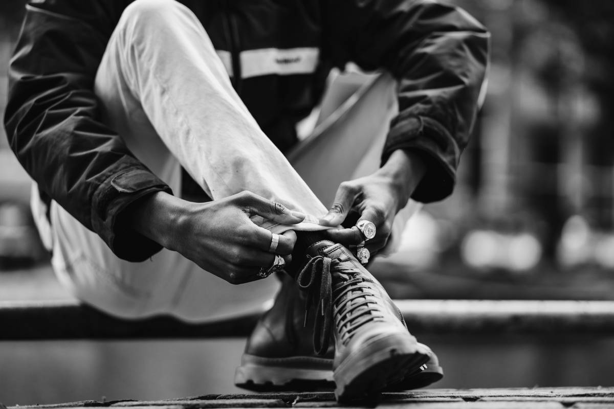 A beginner runner stretching before starting a running routine on a quiet neighborhood street